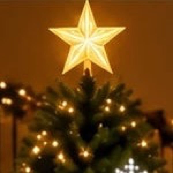 Glowing LED star tree topper on top of a Christmas tree